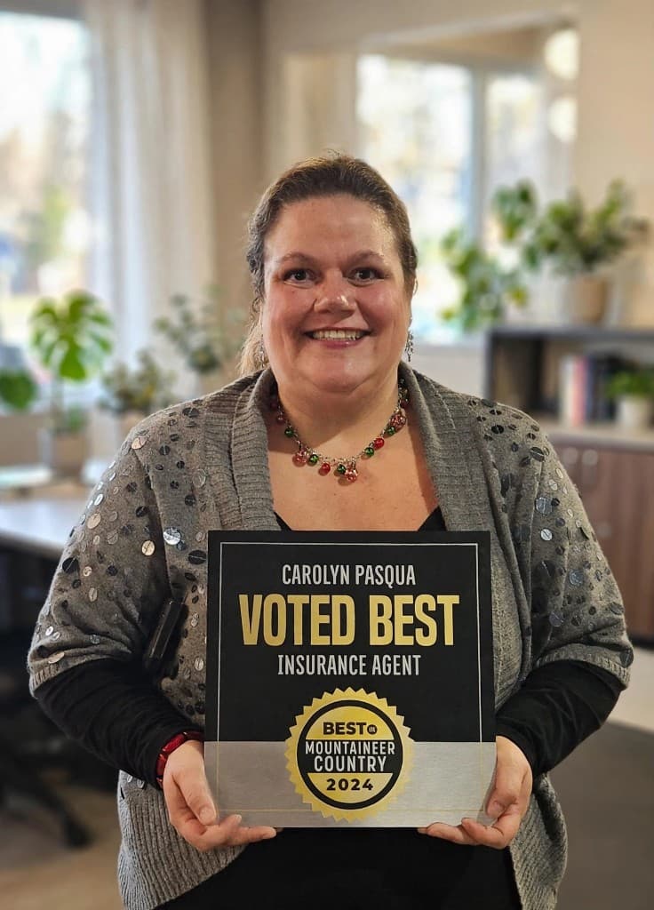 Carolyn Pasqua holding her Best of Mountaineer Country 2024 plaque for Best Insurance Agent